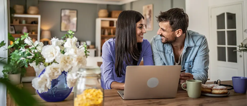 Couple applying for a loan on their laptop